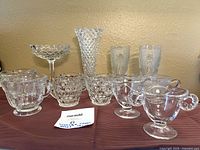 Group view of all clear glass pieces on cloth background