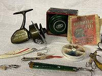 Overall lot showing reel, spool, instruction envelope, lures, fly box
