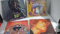 Four Jimi Hendrix vinyl albums including Rainbow Bridge, Axis: Bold as Love, and Electric Ladyland, two still in protective plastic sleeves