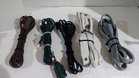 Photo showing all five extension cords coiled, displaying various colors and lengths.