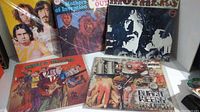 Five vinyl albums laid out showing front covers, including two Mothers of Invention albums with portrait and psychedelic art, Ruben & The Jets cartoon cover, and Burnt Weeny Sandwich collage cover