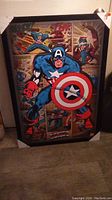 Photo of full framed picture of Captain America in blue costume with shield and retro comic backgrounds.