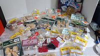 Image showing a wide assortment of packaged wooden and crafting supplies laid out on a surface.