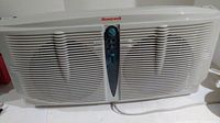 Front view of Honeywell twin window fan showing front grill and control panel with speed settings.