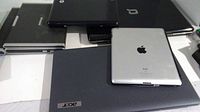 Top view of all laptops stacked with iPad on top