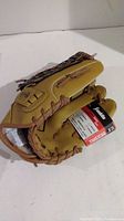 Side and palm view of Franklin Field Master 12 inch baseball glove with original tag attached, showing tan leather and brown laces.
