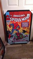 Full view of the framed Spider-Man poster against a white background showing dimensions and overall condition.