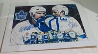Signed picture featuring Wendel Clark and Doug Gilmour in Maple Leafs uniforms with team logo, signatures visible in blue ink.