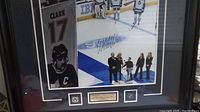 Full view of framed signed hockey photo with surroundings.