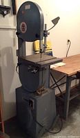 Full front view of gray Delta Rockwell band saw on stand