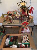 Wide overview of table showing all vintage Christmas ornaments, figurines and decor