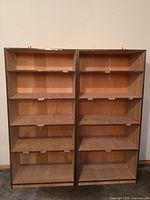 Front view of two wooden shelving units side by side, showing five adjustable shelves each.