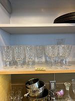 Shelf display of 10 Lenox crystal stemmed glasses, showing diamond cut detail and starburst bases.
