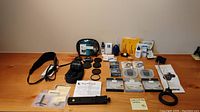 Overview of all items including lens, filters, ring light, plate, strap and cleaning supplies on tabletop