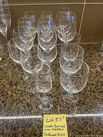 Several Scott Zwiesel wine glasses arranged on a granite counter, various sizes