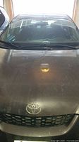 Front view of gray Toyota Matrix hood and windshield