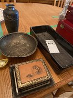 Lot items displayed on wooden table including tray, vase, bowl, and trinket box, all visible with details