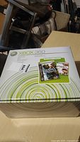 Original Xbox 360 box showing included games and branding