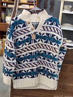 Front view of the wool sweater with patterned design, showing collar and buttons.