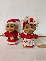 Two vintage holiday-themed troll dolls displayed side by side on a plain white background.
