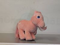 Front angle of pink My Little Pony plush figure showing face and body with white spots