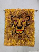 Front view of a shaggy vintage lion rug wall hanging, showing the full rug and wooden pole for hanging.