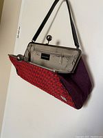 Interior of vintage purse showing zippered pocket, lining, and label stating Made in Canada.