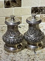 Pair of silver salt and pepper shakers showing overall design and size