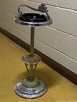 Full view of the vintage standing ashtray showing chrome stand, dark glass liner, and detailed base.