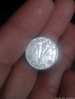 Reverse side of 1944 Canadian 5 Cent coin showing large V, date 1944, maple leaves, and word CANADA.