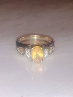 Front view showing oval citrine center and accent stones