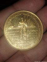 Front side showing miner holding pickaxe with metallurgical information and inscriptions around edge.