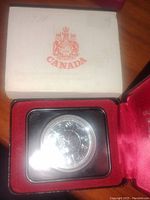 Closed display box with Canadian coat of arms and 'CANADA' text, showing 1977 inscription on lid