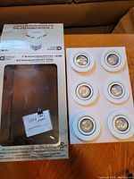 Photo of unopened Commercial Electric 3 inch recessed lighting kit box showing six lighting fixtures inside white molded insert and front box label with product details.