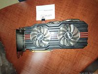 Front and top angled view of ASUS GTX 670 graphics card showing dual fans, red accents, and PCIe connector.