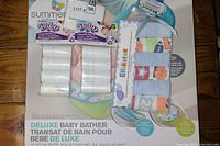Close-up photo of the Deluxe Baby Bather in original packaging showing branding and included items.