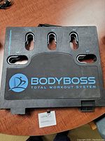 Top view of the folded Body Boss workout board showing branding and numbered slots