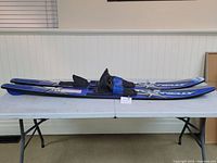 Pair of Connelly Quantum water skis laid on a table, showing full length and bold Connelly logo