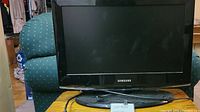 Front view of Samsung LN228B360C5D monitor on stand with visible Samsung logo and screen in off state.