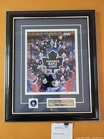 Framed 2003-2004 Toronto Maple Leafs 'Team Leaders' poster with player images, Toronto Maple Leafs logo patch, and name plaque inside a black and gray multi-layered frame.