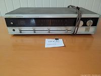 Front view of vintage Lloyd's AM/FM stereo receiver showing entire unit with power cord and control panel including tuning dial and sliders.