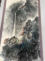 Full view of vintage Chinese scroll painting depicting waterfall, palace, and surrounding landscape on fabric mount.