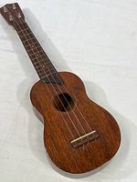 Full view of the mahogany ukulele showing body and neck.
