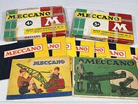 Two Meccano supplemental kits and several instruction booklets displayed together, showing condition and variety of items.