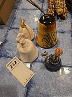 Top view of all 5 bells arranged showing variety in material and color including porcelain and wood.