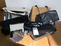Group photo of eight assorted handbags with various materials and designs placed together on a surface.