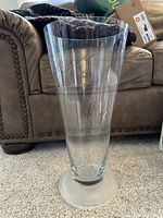 Side view of tall clear glass floor vase showing cylindrical shape and frosted base.