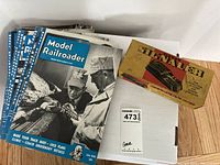 Stack of 11 Model Railroader magazines with distinct covers from 1949 to 1952, showing model trains and layouts on each cover.