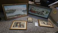 Overview of five framed wall art pieces showing different scenes including coastal lighthouse, horse-drawn sleigh, Christmas and winter themes