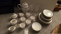 Complete Mikasa Petit China Black Tie pattern service pieces with included Tiffany & Co. champagne glasses